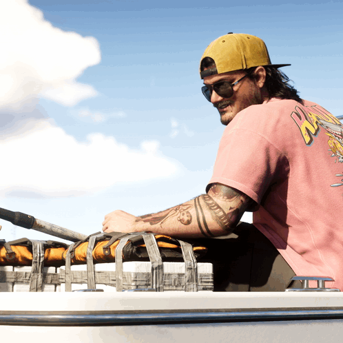 Man in Pink Shirt Saying NZ Sits on Boat