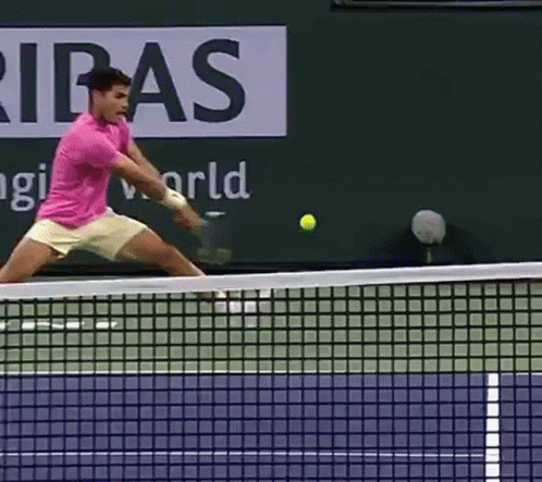 Man In Pink Shirt Swinging Tennis Racquet GIF
