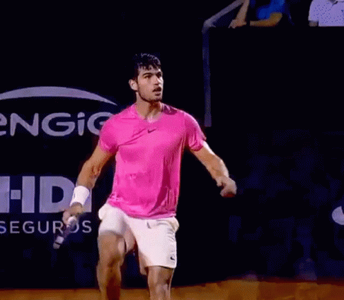 Man In Pink Shirt, White Shorts Holding Tennis Racquet GIF
