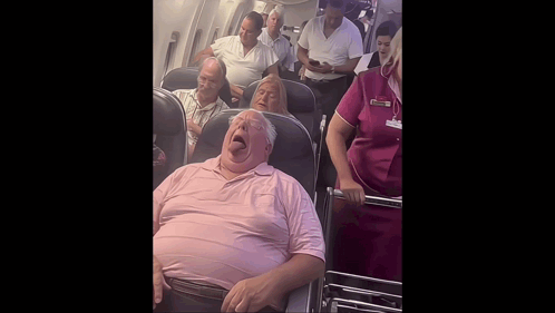 Man in Pink Shirt Yawning on Airplane