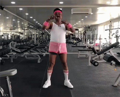 Man in Pink Shorts and White Adidas Socks in Gym