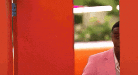 Man in Pink Suit at Red Door