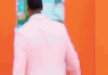 Man In Pink Suit Walking Through Door GIF