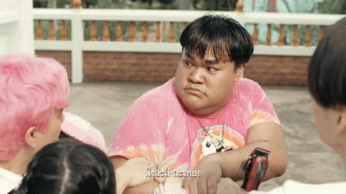Man In Pink Tie Dye Shirt Surrounded By People GIF