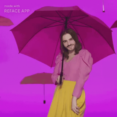 Man in Pink Top and Yellow Skirt Holding Pink Umbrella