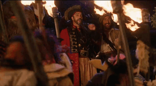 Man in Pirate Costume With Group Holding Torches