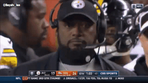 Man in Pittsburgh Steelers Hat Talking Into Microphone Watching Football