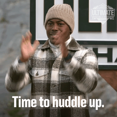 Man In Plaid Jacket And Beanie Saying Huddle Up GIF