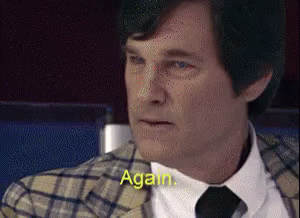 Man in Plaid Jacket and Tie Says Again