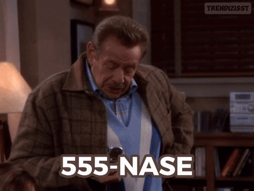 Man in Plaid Jacket Holding Cell Phone 555-nase