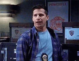 Man in Plaid Shirt and Badge