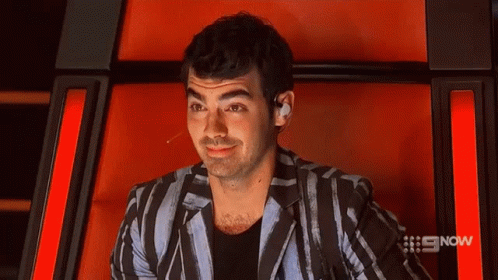 Man In Plaid Shirt And Black Jacket With #Ama5 Hashtag GIF