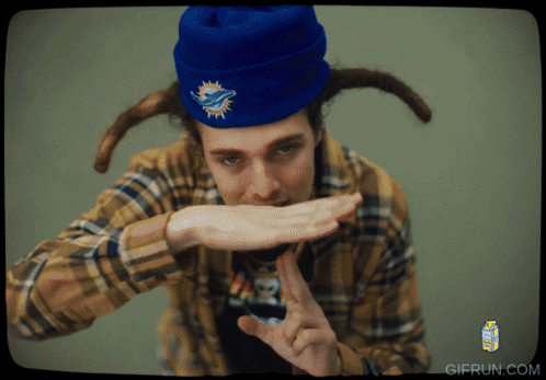 Man in Plaid Shirt and Blue Beanie With Dolphins Logo