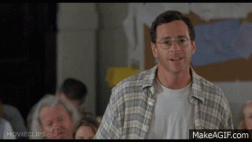 Man In Plaid Shirt And Glasses Faces Crowd GIF