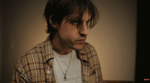 Man in Plaid Shirt and Necklace With I Love You Tattoo