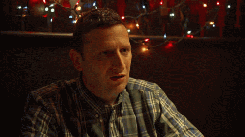 Man in Plaid Shirt and Tie Asking What