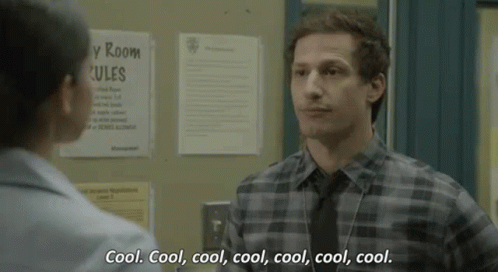 Man In Plaid Shirt And Tie Talking To Woman In Hallway GIF