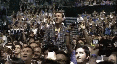 Man in Plaid Shirt at Concert
