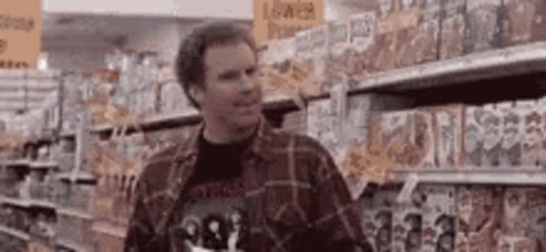 Man in Plaid Shirt at Grocery Store Shelf