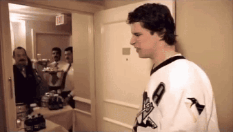 Man in Plaid Shirt at Hockey Webcast Locker