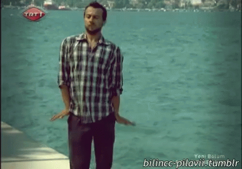 Man In Plaid Shirt By Water With TRT Logo GIF