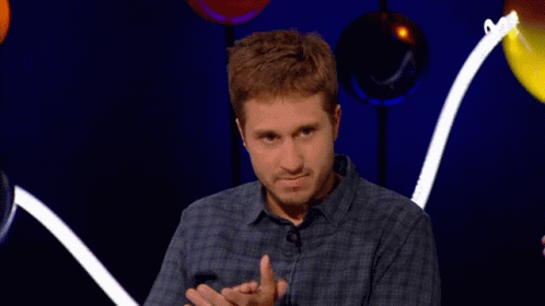 Man in Plaid Shirt Clapping With Balloons