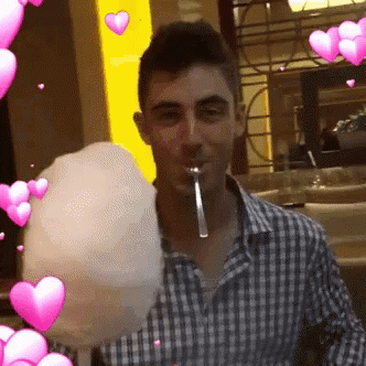 Man In Plaid Shirt Eating Cotton Candy GIF