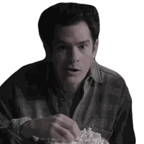 Man in Plaid Shirt Eating Popcorn