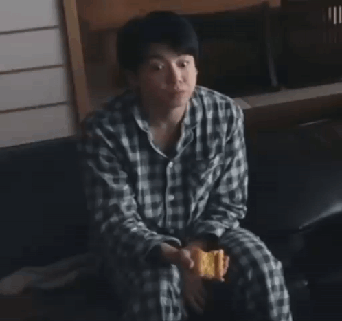 Man in Plaid Shirt Eating Snack