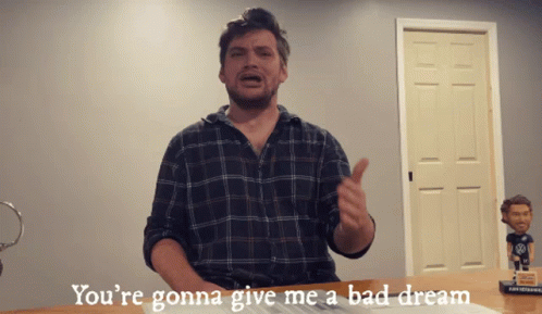 Man in Plaid Shirt Giving Thumbs Up