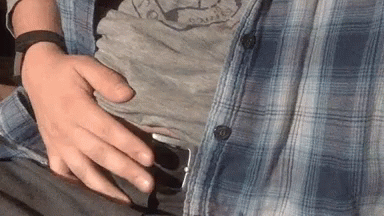 Man In Plaid Shirt Holding Belly GIF