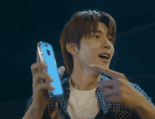 Man in Plaid Shirt Holding Blue Phone
