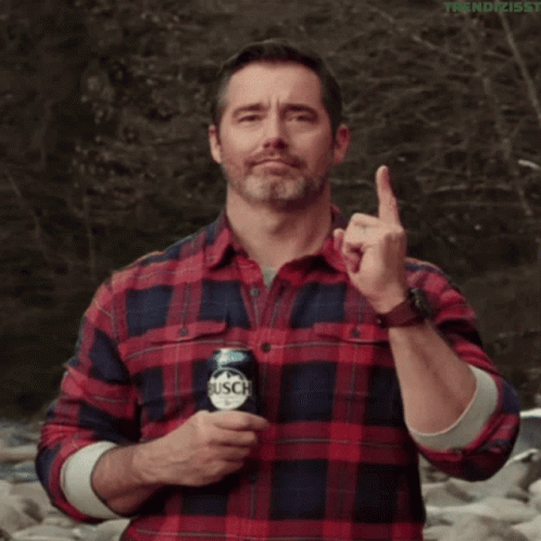 Man in Plaid Shirt Holding Busch Can