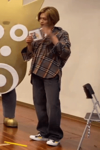 Man in Plaid Shirt Holding Card