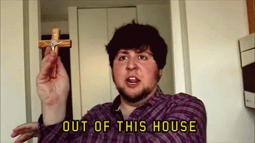 Man in Plaid Shirt Holding Cross Out of This House