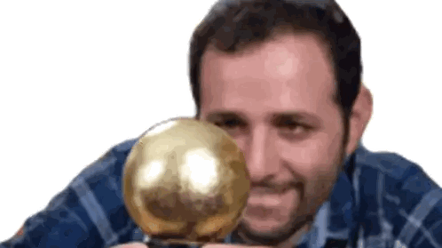 Man in Plaid Shirt Holding Gold Ball