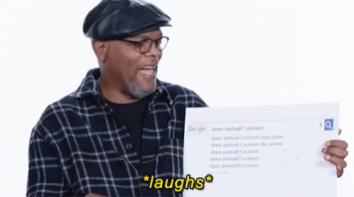 Man in Plaid Shirt Holding Laughs Sign
