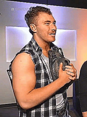 Man In Plaid Shirt Holding Rock GIF
