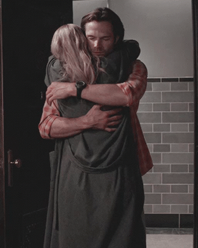 Man In Plaid Shirt Hugging Woman In Black Dress GIF