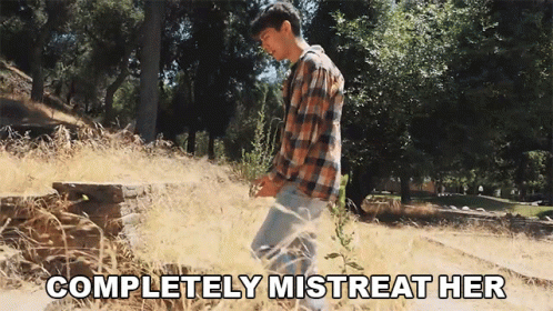 Man in Plaid Shirt in Field Saying Completely Mistreat Her