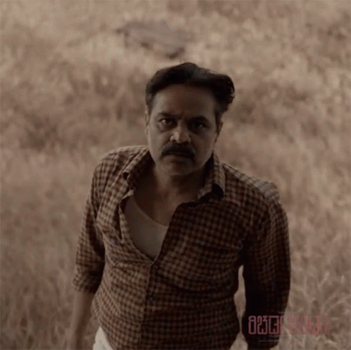 Man in Plaid Shirt in Field