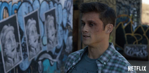 Man in Plaid Shirt in Front of Netflix Graffiti