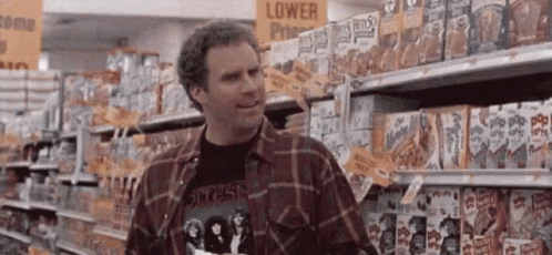 Man in Plaid Shirt in Grocery Aisle