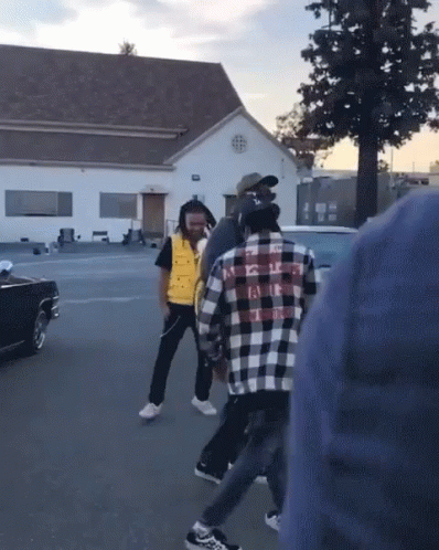 Man In Plaid Shirt Kicking Another Man GIF