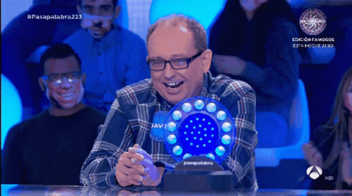 Man in Plaid Shirt Laughing Holding Blue Javi Object