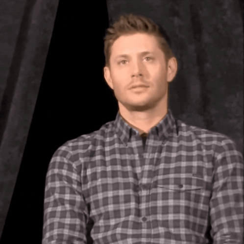 Man in Plaid Shirt Looking at Camera