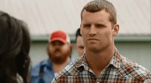 Man in Plaid Shirt Looking at Woman in Red Hat