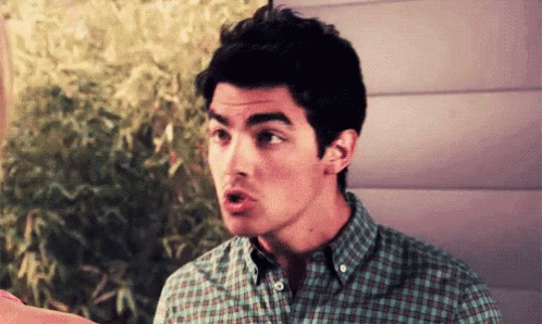Man In Plaid Shirt Making A Face GIF