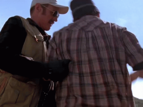 Man in Plaid Shirt Next to Man in Baseball Cap