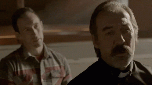 Man in Plaid Shirt Next to Man in Black